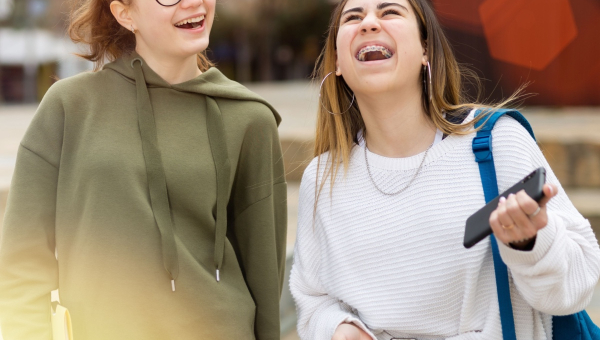 A girl with Houston braces laughing with her friend